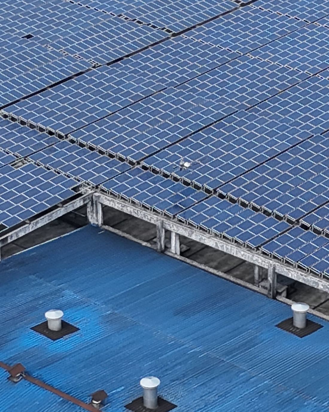 Dense solar array covering an industrial roof