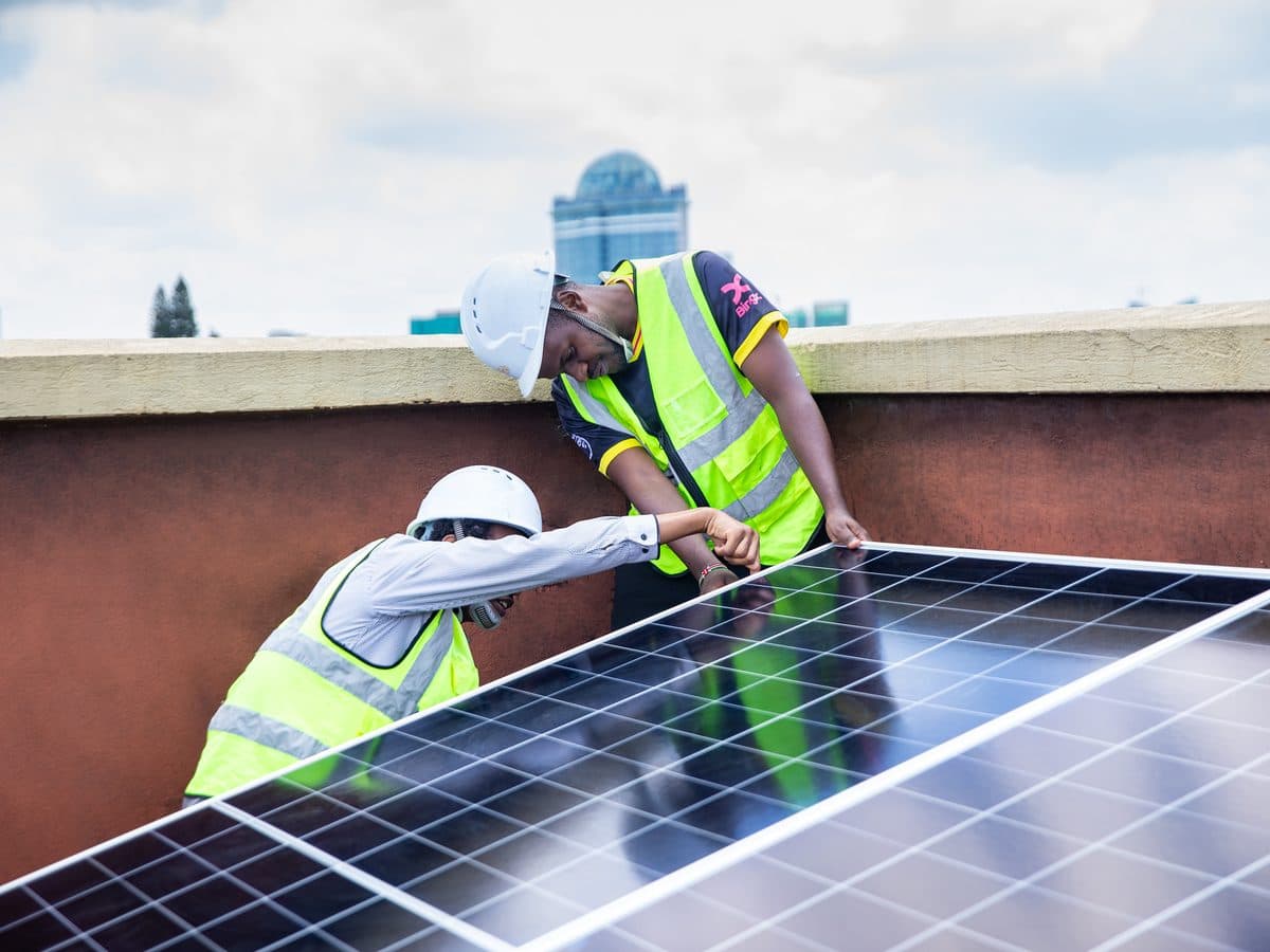 Tesni Energies crew fitting solar panels on a Nairobi rooftop