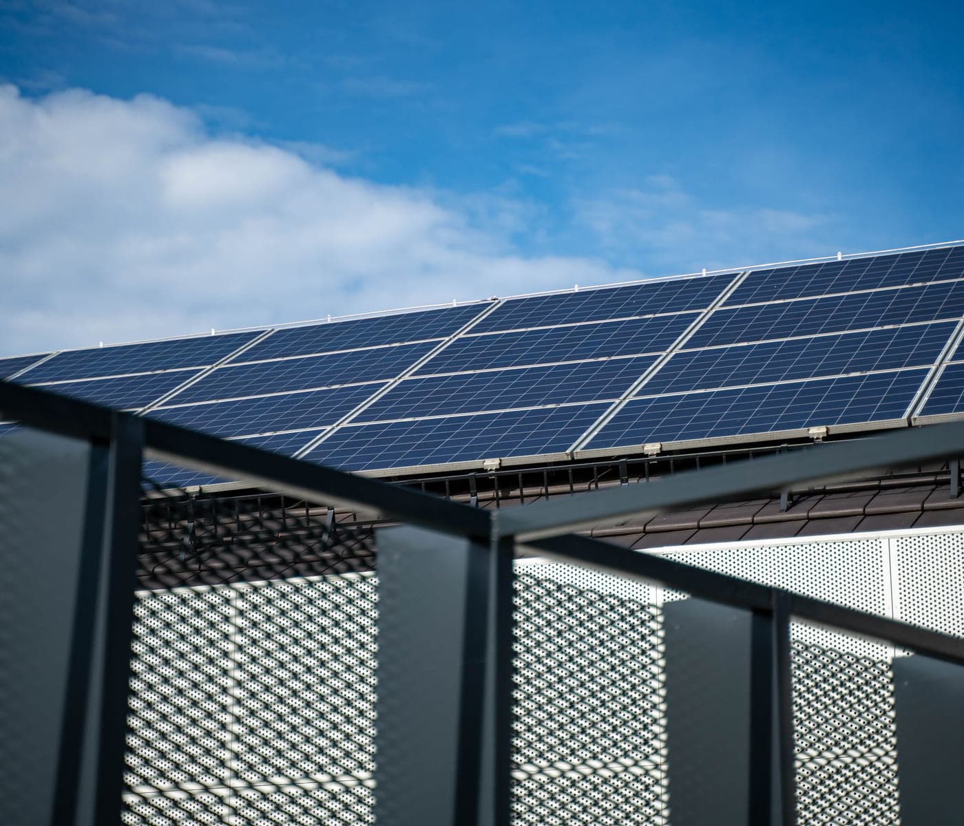 Solar panels mounted along the roofline of a commercial building