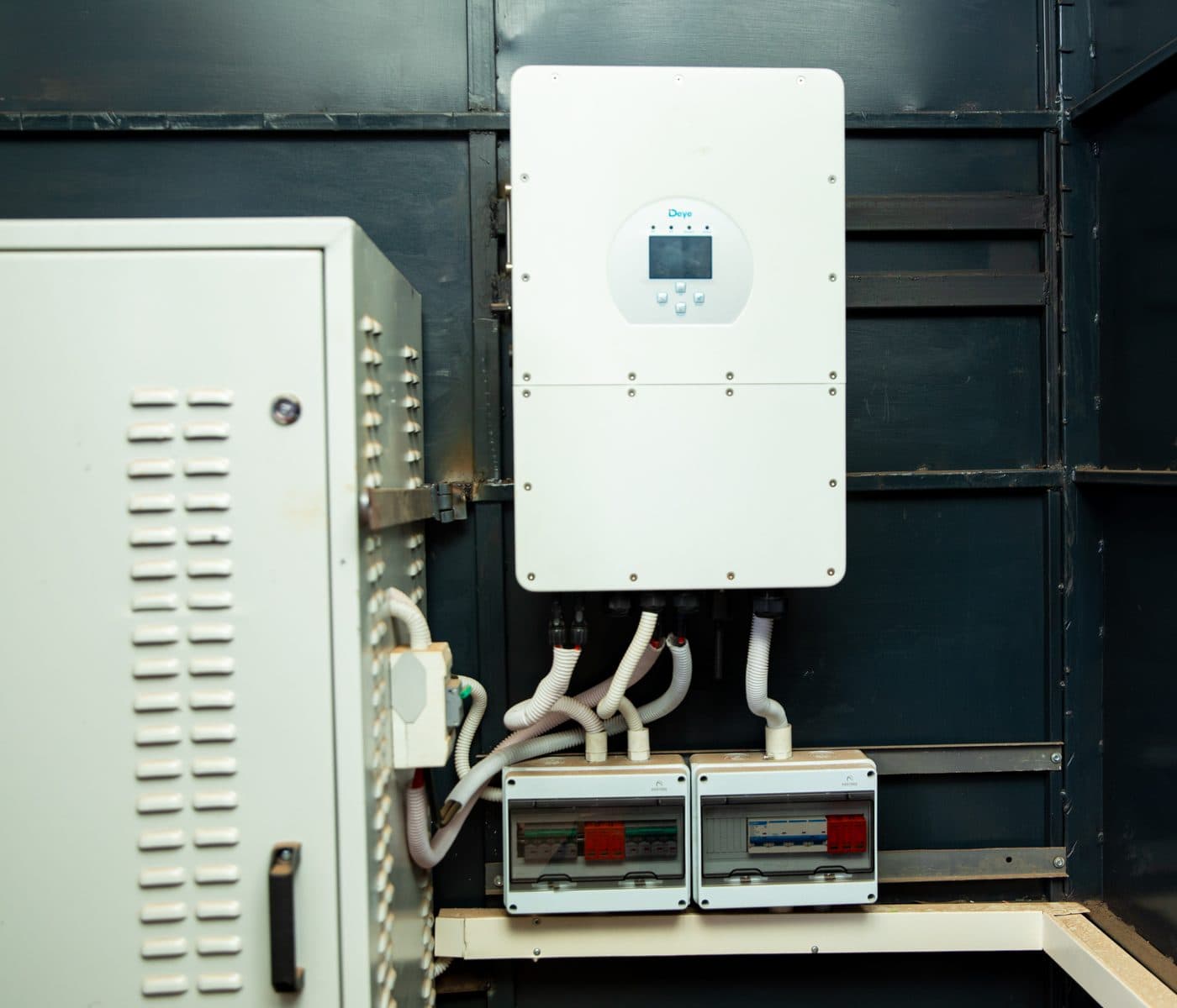Solar inverter and distribution boards checked during an energy audit in Kenya
